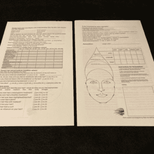 A pair of papers with a face drawn on them.