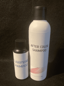 A bottle of hair color and a spray bottle.